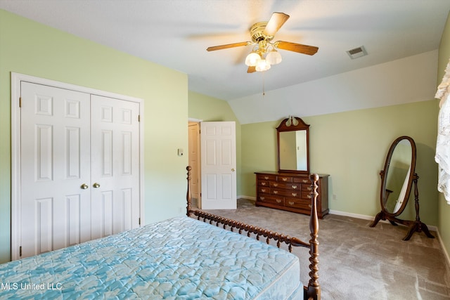 bedroom with visible vents, lofted ceiling, ceiling fan, carpet flooring, and a closet