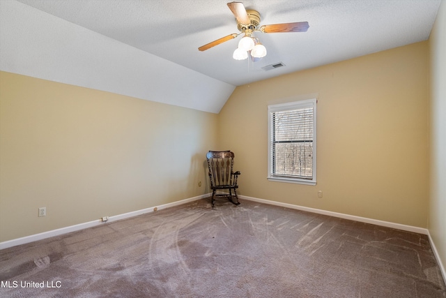 additional living space featuring baseboards, visible vents, a ceiling fan, lofted ceiling, and carpet floors