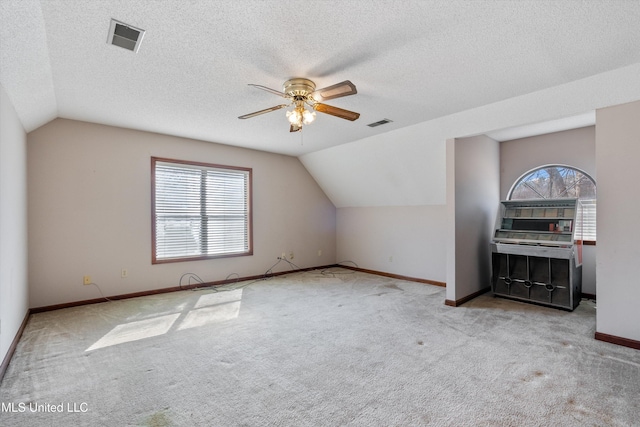 bonus room with carpet floors, lofted ceiling, visible vents, and baseboards