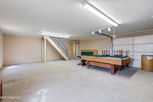 game room with a garage, pool table, and concrete floors