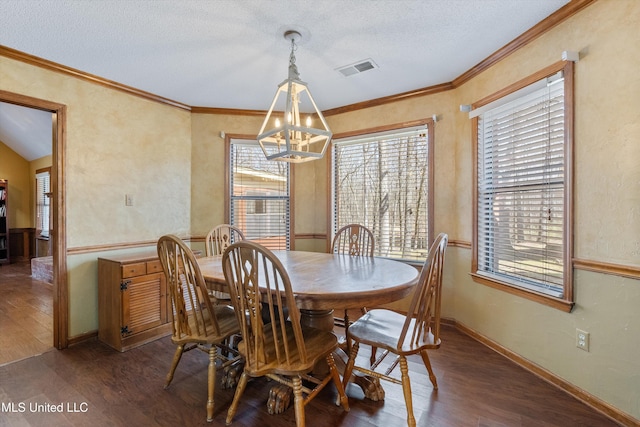 dining room with ornamental molding, wood finished floors, and visible vents