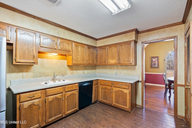 kitchen with black dishwasher, dark wood finished floors, light countertops, and a sink