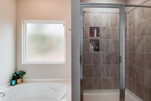 bathroom featuring separate shower and tub