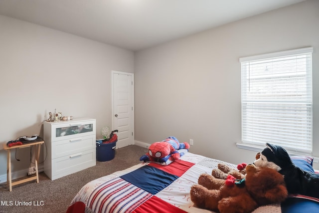 bedroom featuring dark colored carpet