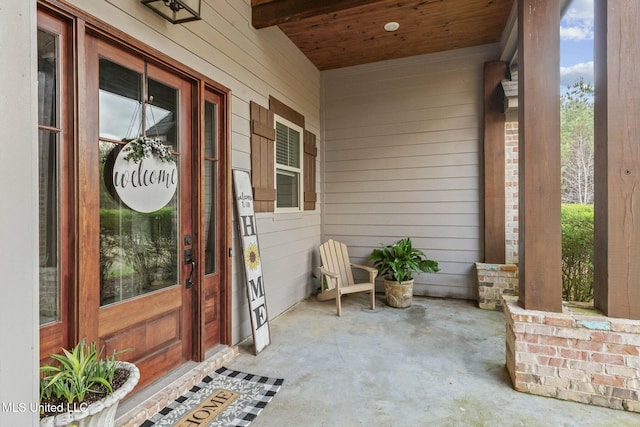 view of exterior entry with a porch