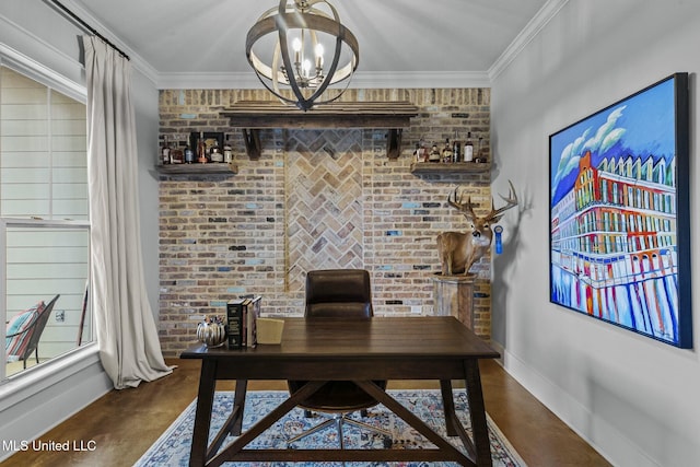 office featuring crown molding, brick wall, and an inviting chandelier