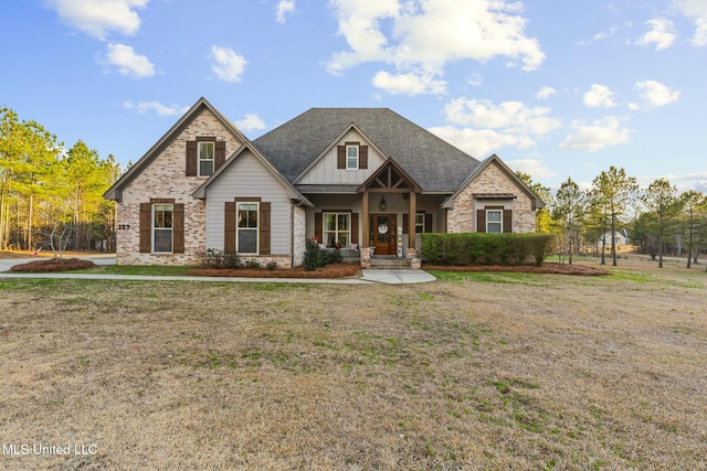 craftsman inspired home featuring covered porch and a front lawn