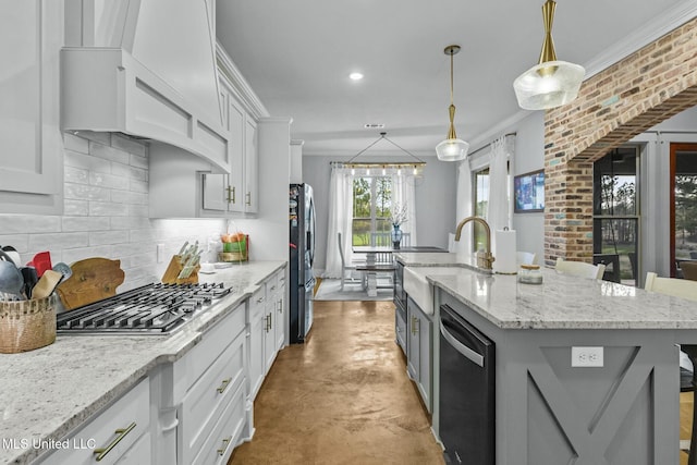 kitchen featuring appliances with stainless steel finishes, a kitchen island with sink, and white cabinets