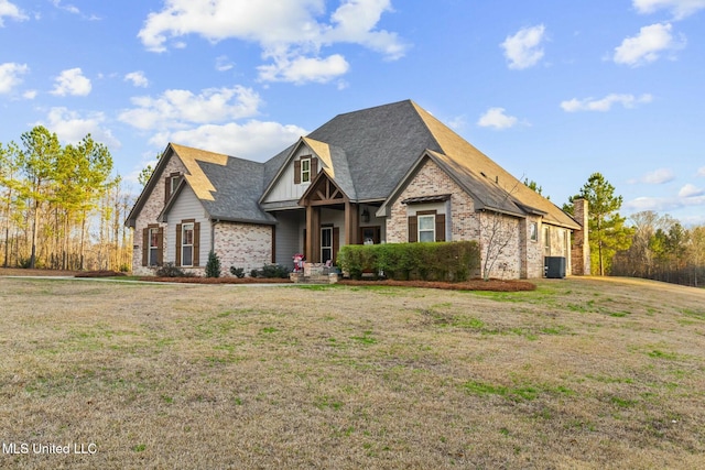 view of front of house with central AC and a front lawn