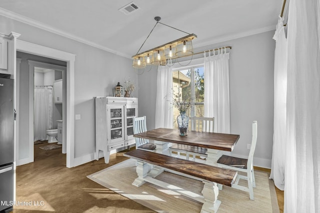 dining space featuring ornamental molding