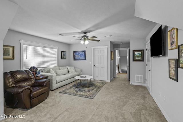 living room featuring light carpet and ceiling fan