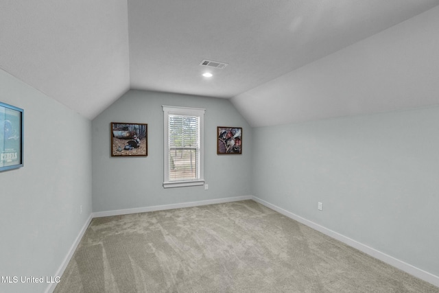 additional living space with lofted ceiling and light colored carpet