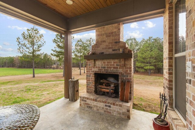 view of patio / terrace featuring an outdoor brick fireplace