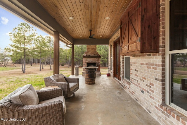 view of patio / terrace with an outdoor brick fireplace and ceiling fan