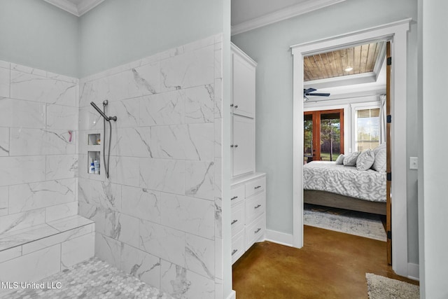 bathroom featuring crown molding and a tile shower