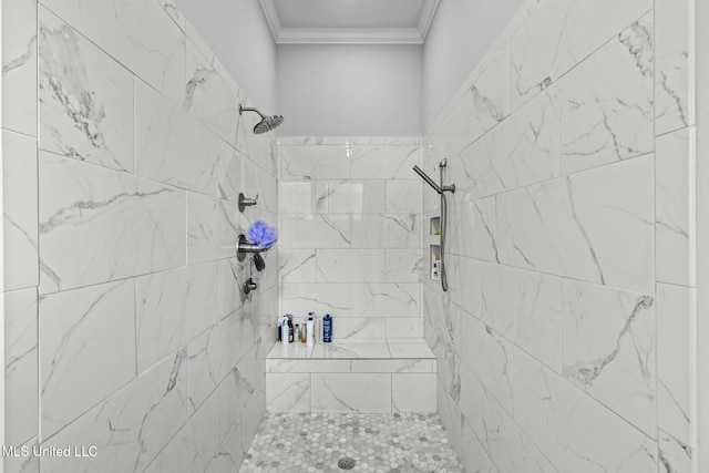 bathroom with crown molding and tiled shower