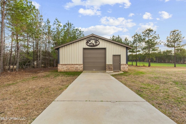 view of outbuilding featuring a garage and a lawn