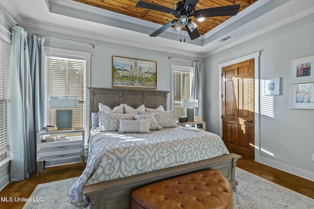 bedroom with crown molding, ceiling fan, and a raised ceiling