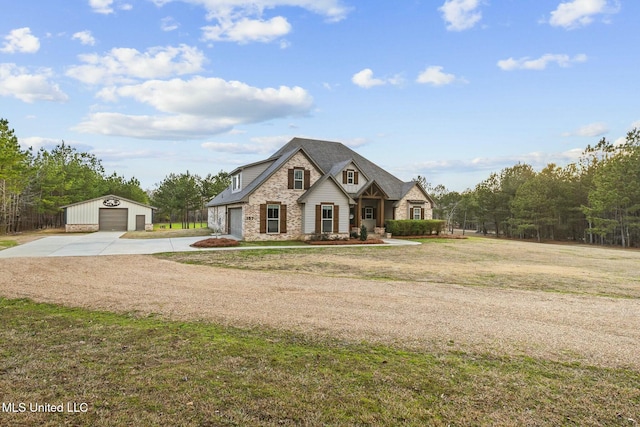 view of front of property with an outbuilding, a garage, and a front lawn