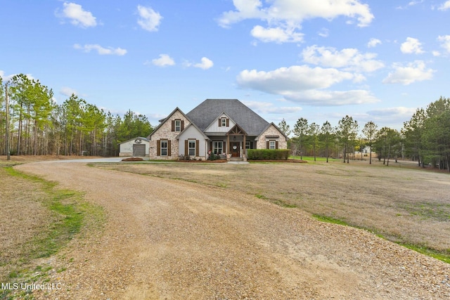 french country home featuring a front lawn and covered porch