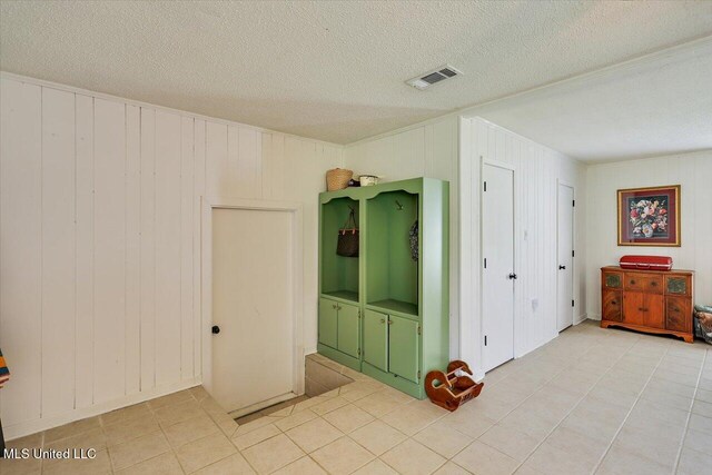 12661 Springridge Rd, Terry, MS 39170 - unfurnished bedroom featuring a textured ceiling, light tile patterned floors, and crown molding