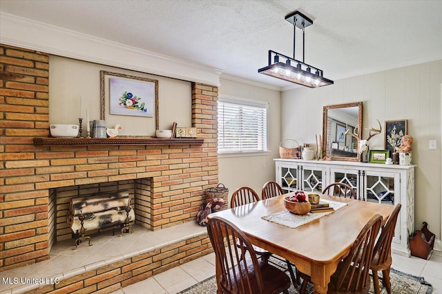 12661 Springridge Rd, Terry, MS 39170 - dining area featuring tile patterned flooring, ornamental molding, a textured ceiling, and a brick fireplace