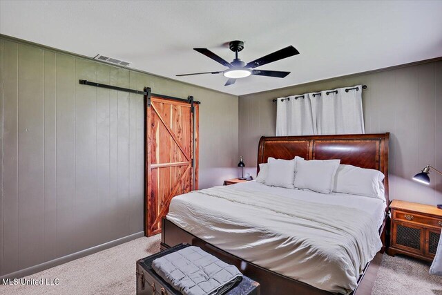 12661 Springridge Rd, Terry, MS 39170 - carpeted bedroom featuring a barn door and a ceiling fan