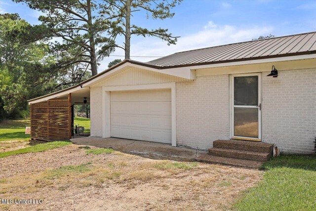 12661 Springridge Rd, Terry, MS 39170 - exterior space featuring entry steps, brick siding, an attached garage, and metal roof