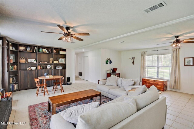 12661 Springridge Rd, Terry, MS 39170 - living area featuring a ceiling fan, light tile patterned floors, and a textured ceiling