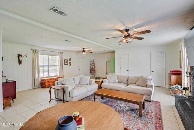 12661 Springridge Rd, Terry, MS 39170 - living area featuring light tile patterned floors, ceiling fan, and a textured ceiling