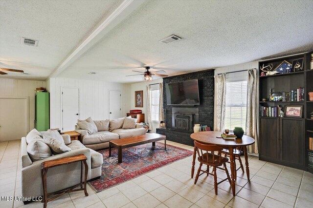 12661 Springridge Rd, Terry, MS 39170 - living room featuring ceiling fan, light tile patterned flooring, a textured ceiling, and a brick fireplace
