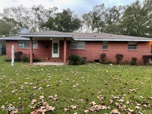 rear view of property with a yard