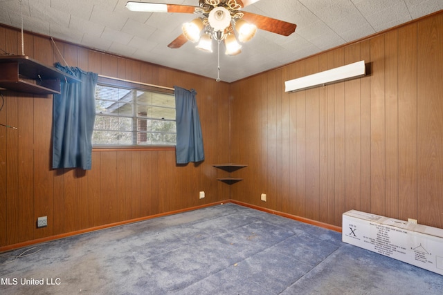 empty room featuring dark colored carpet, ceiling fan, and wooden walls