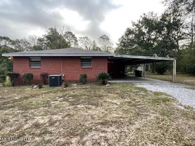 view of side of home featuring central AC and a carport