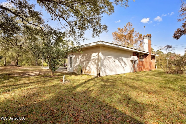 view of side of property with a lawn