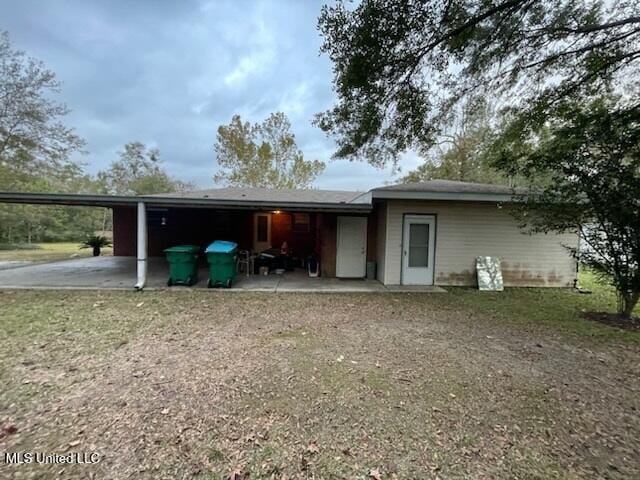 rear view of house featuring a carport