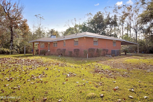 14071 Duckworth Rd, Gulfport, MS 39503 - view of side of property with central AC unit, brick siding, a carport, and a yard
