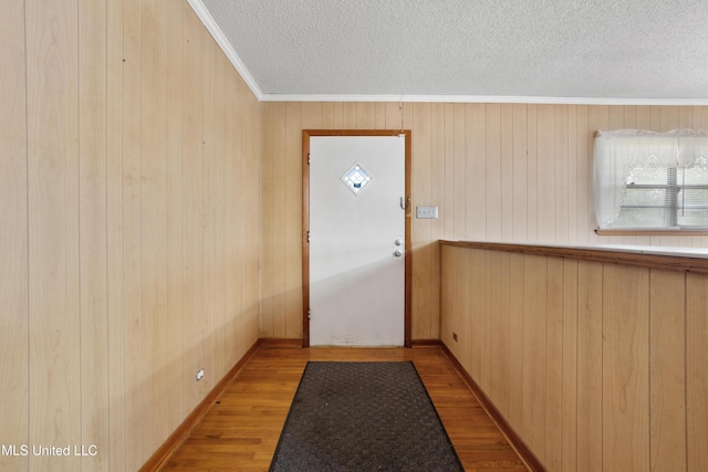 14071 Duckworth Rd, Gulfport, MS 39503 - entryway featuring wood finished floors, a textured ceiling, ornamental molding, wood walls, and healthy amount of natural light