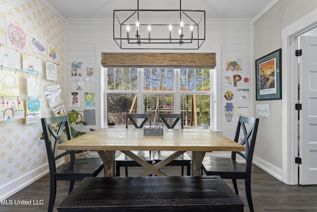 dining space with an inviting chandelier, wallpapered walls, baseboards, and dark wood finished floors