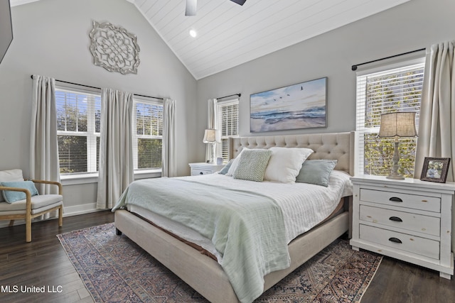 bedroom featuring baseboards, ceiling fan, multiple windows, and dark wood finished floors