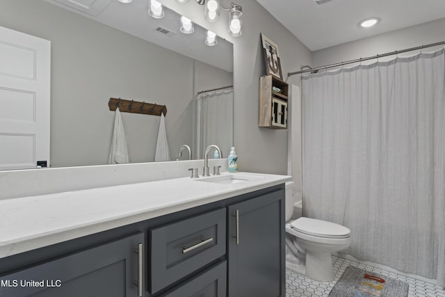 bathroom with shower / bath combination with curtain, toilet, vanity, and tile patterned floors