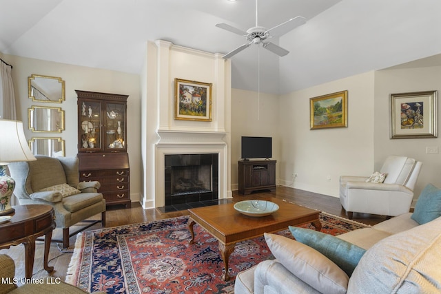 215 Azalea Ct, Brandon, MS 39047 - living room featuring lofted ceiling, wood finished floors, ceiling fan, baseboards, and a tile fireplace