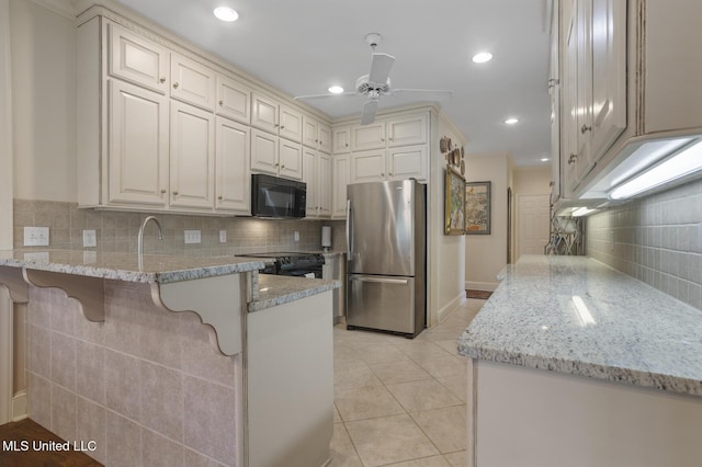 215 Azalea Ct, Brandon, MS 39047 - kitchen featuring black appliances, a peninsula, backsplash, light stone countertops, and a ceiling fan
