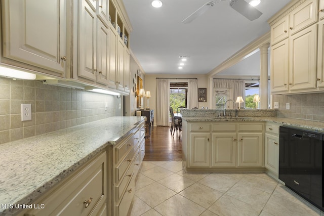 215 Azalea Ct, Brandon, MS 39047 - kitchen featuring black dishwasher, cream cabinetry, a sink, tasteful backsplash, and light stone counters