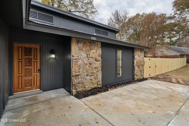 view of exterior entry featuring a patio