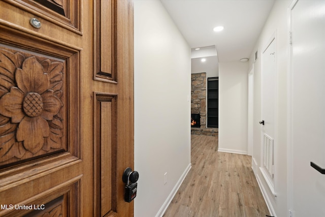 hallway with light hardwood / wood-style floors