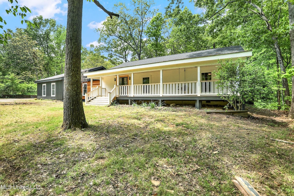 single story home with covered porch and a front lawn