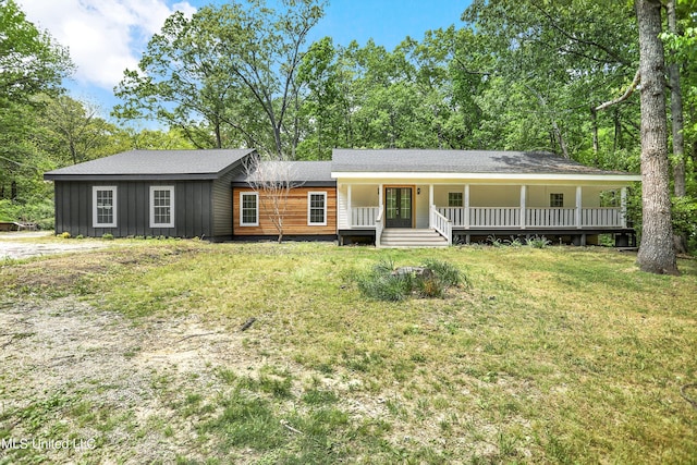 ranch-style home with a front yard and a porch