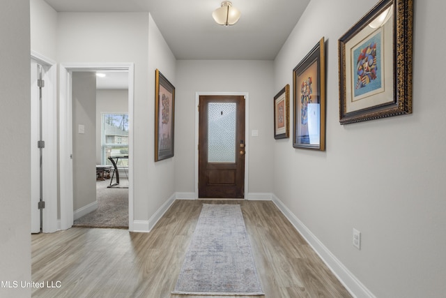 entryway featuring light wood-type flooring and baseboards