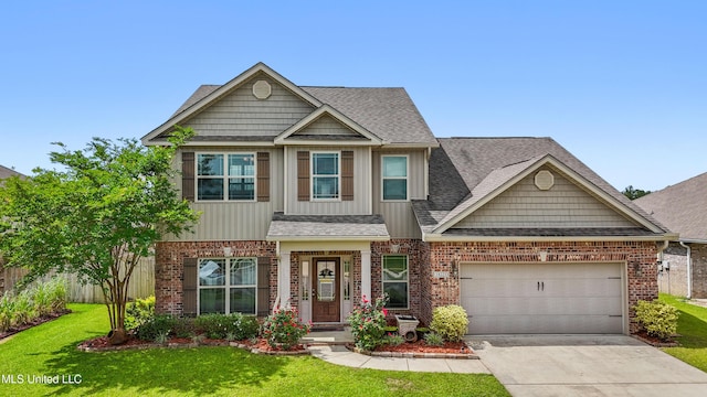 18225 Tulip Cv, Gulfport, MS 39503 - craftsman inspired home featuring brick siding, roof with shingles, driveway, and a front lawn